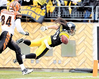 Pittsburgh Steelers safety Troy Polamalu (43) scores a touchdown on an interception as Cincinnati Bengals tight end Jermaine Gresham (84) defends during the second quarter of an NFL football game, Sunday, Dec. 12, 2010, in Pittsburgh.