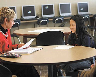 Patte Ulery, left, reads over a fable with Wendy Liu, a sixth-grader at Austintown Middle School. Wendy will be exiting the English tutoring program this year. She grew up in China.