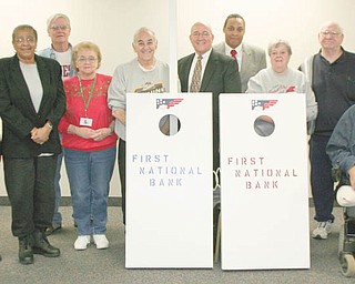 Let the games begin: Austintown Senior Center, 100 Westchester Drive, opened in October and is already a busy place. One of the attractions for senior citizens is the opportunity to enjoy the new cornhole games. Made by seniors at Lordstown Senior Center, the games were donated to the Austintown center by First National Bank, which also recently provided the center with five computer desks. Ready for the games to begin are, from left, Ann Clark; Leta Sims; Jim Miller; Elizabeth and Alex Panno; Richard Stevens, business development officer with FNB; Tim Richardson of FNB; Myra and Gary Brant; and Jack Myers.