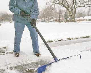 Janet Zolla, of Boardman, shovels snow from her Glenwood Avenue driveway on Tuesday, Dec. 14.