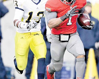 Ohio State running back Dan Herron (1) runs away from Michigan safety Carvin Johnson (13) during third quarter action in an NCAA college football game on Saturday, Nov. 27, 2010, in Columbus, Ohio. Herron finished the game with 175 yards and a touchdown on 22 carries on the Buckeyes 37-7 win.