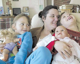 Joyce Koellner and her daughters Colleen, left, and Corra, 6, at Beatitude House.