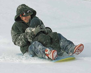 John Hallett takes his little brother Steve Hallett for a ride down a sledding hill at the Wick Recreation Area.