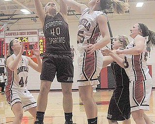 BASKETBALL - (40) Kayleigh Lipke of Boardman and (15) Abby Baker fight for the ball during their game Wednesday night in Canfield. (44) Sabrina Mangapora (23) Sarah Vrabel of Canfield and (21) Brooke Meenachan of Boardman are in on the play.
