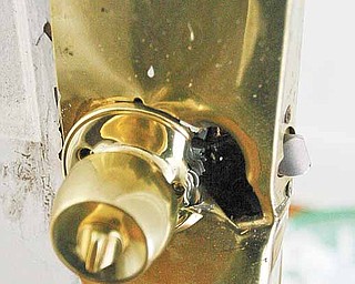A shotgun blast blows the latch off a bedroom door as part of a tactical-entry training exercise by members of the Mahoning Valley Violent Crimes Task Force.