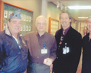Sharing the wealth: Funds to benefit needy veterans and their families were raised during a yearly reverse raffle and basket auction sponsored by Catholic War Veterans Post 1292 of Youngstown. Mark Bell, administrator of the Louis Stokes Veterans Administration Clinic on Belmont Avenue, at left, accepted the $1,200 donation during a meeting with, from left, Al Bisker, Post 1292 trustee; Bob Brienke, volunteer service officer at the clinic; and Gary Barnes, commander of Post 1292.