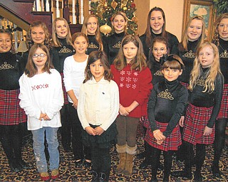 Spreading good, old-fashioned cheer: On Dec. 12 members of the Junior Division of the Golden Rose Queen of Ireland LAOH of Mahoning County presented Christmas shows and took homemade cookies to residents at two nursing homes as a service project. First, the juniors performed at noon at Assumption Village, where they gathered by the Christmas tree, above, for a group picture. They also sang all the favorite Christmas songs, followed by an exhibition of Irish Dance by students of the Theresa Burke School of Irish Dance. At 2 p.m. the juniors presented the program and cookies to residents at the Inn at Christine Valley, where Shamus Kerrigan, grandfather of juniors Vice President Christine Kerrigan, is a resident. Christine qualified in the Midwest Oireachtas to compete in the World Irish Dance Championships in Dublin, Ireland, in 2011.