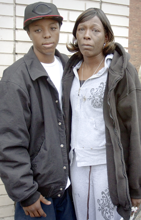 Geoffrey Hauschild|The Vindicator.April Jackson and her son Joseph stand outside a friend's business on Hylda Ave. after speaking about her son who was killed last year and whose killers have never been brought to justice.