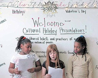 Third grade students (from left to right ) Jasmine Telfair Raelynn Haefke and Keriah Johnson present their favorite holiday to the class: Christmas. Third grade students of Woodside Elementary school invited family to join them Friday morning for a presentation of holidays from around the world and across the calendar.