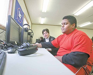 Nate Masterson and Janet Polish work on some course work at the new alternative school at Fitch High School which allows any interested student to join the program and learn from home.