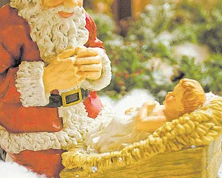 A kneeling Santa and Baby Jesus lay amidst Christmas Decorations at The Rescue Mission in Youngstown on Tuesday afternoon.