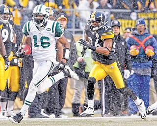 New York Jets' Brad Smith (16) returns the opening kickoff Pittsburgh Steelers safety Will Allen (26) for a touchdown) in the first quarter of the NFL football game, Sunday, Dec. 19, 2010 in Pittsburgh.