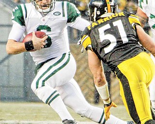New York Jets quarterback Mark Sanchez, left, scrambles during the first quarter of an NFL football game against the Pittsburgh Steelers in Pittsburgh, Sunday, Dec. 19, 2010. In pursuit is Steelers linebacker James Farrior (51).
