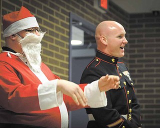 Steve Gasior, an eighth-grade science teacher, donned at Santa suit Monday as part of the Toys for Tots talent show at Choffin Career and Technical Center. Sgt. Robert Eggleston of the Marines took in the show with Santa. The talent show was a fundraiser for Toys for Tots and raised $900 for the cause.