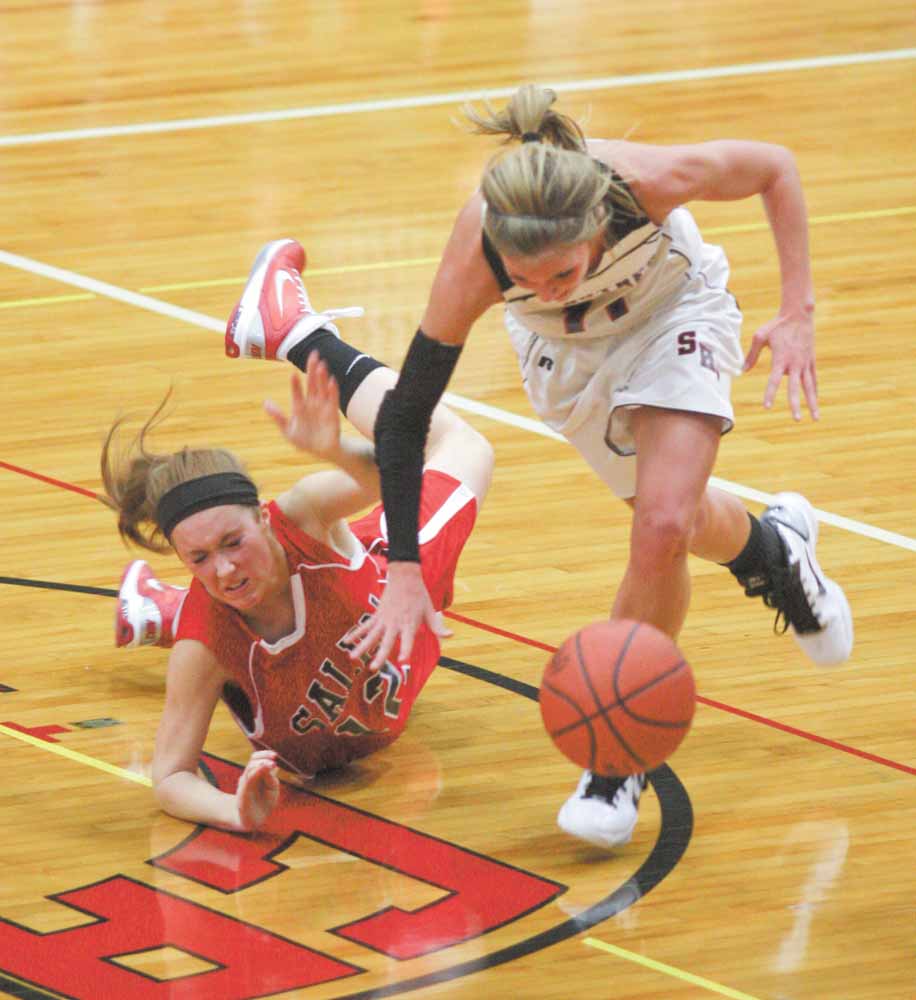 (11) Katelyn Ardale of Struthers and (12) Peyton Meals get tangled up going for the ball during their game Monday night in Struthers.