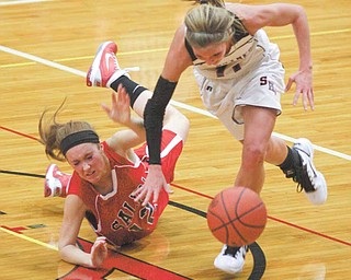 (11) Katelyn Ardale of Struthers and (12) Peyton Meals get tangled up going for the ball during their game Monday night in Struthers.