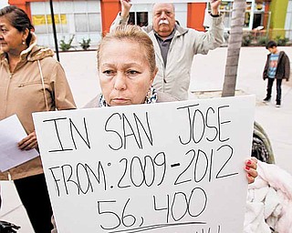 In this Sept. 21, 2010 photo, demonstrators hold signs in front of Bank of America in San Jose, Calif., during a rally protesting thousands of bank foreclosures in San Jose.