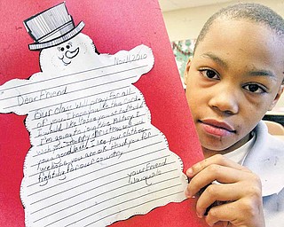 Taft Elementary fourth grader Jaiquale Gibbs displays the letter that he wrote to military service people in Afghanistan. The letters were a writing project in his class. Jaiquale wrote that his class would pray for the service people and that he wants to join the military.