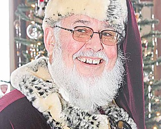Howard Huffman of Hubbard has played Santa for about a year. Last week he greeted children at the Salem Airport.