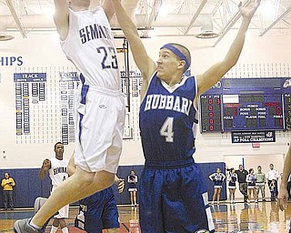 BBALL - (23) Brandon Maceyko drives for two as (4) Tyler Duez gets a hand in his face during their game Tuesday night in Poland.
