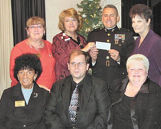 Helping to get Toys for Tots: At their annual Toys for Tots auction the Warren Republican Women’s Club raised $1,368 for the Marine Corps’ annual campaign to help area children at Christmas. They presented the check to a Marine representative Dec. 2 at DiLucia’s banquet center in Warren. In the front row, from left to right, are Shelby McElravy, second vice president and auction chairwoman; Mike Fuchilla, auctioneer; and Cary Ann Koren, first vice president. In the second row are Gail Druschel, auction committee member; Barbara Tryon, president; Chief Warrant Officer 4 Emiliano DeLeon of Toys for Tots, who is holding the check; and Dorie Harris, hostess.