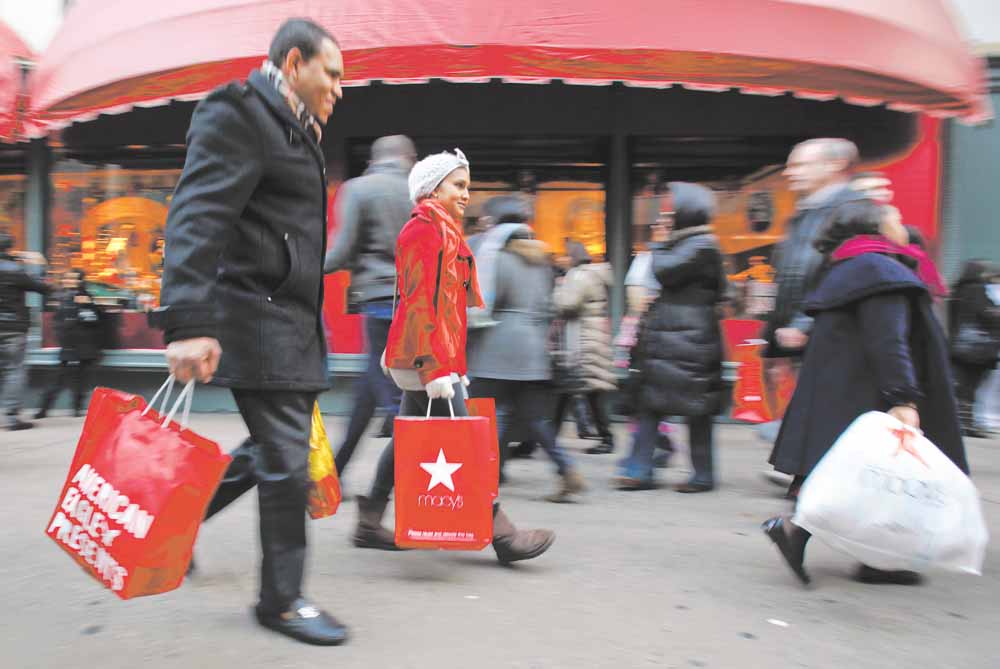 In this Dec. 18, 2010 photo, shoppers are photographed on 34th Street, in New York. Holiday shoppers are racing to the end of the season at a more feverish pace this year, with retail revenue up 5.5 percent during the last weekend before Christmas.