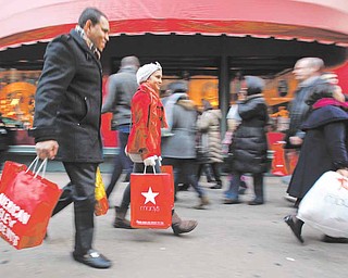 In this Dec. 18, 2010 photo, shoppers are photographed on 34th Street, in New York. Holiday shoppers are racing to the end of the season at a more feverish pace this year, with retail revenue up 5.5 percent during the last weekend before Christmas.