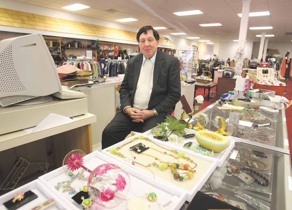 Gary Abrams, president and chief executive officer of Kolby’s Clothing on East State Street, Salem, poses with some of the items available at his store. The longtime clothing store is closing, due in part to the declining economy, and leaving downtown with few shopping venues.