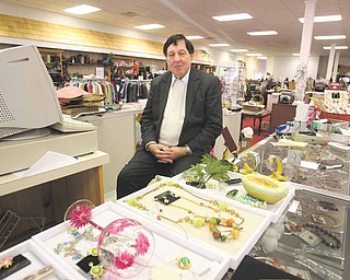 Gary Abrams, president and chief executive officer of Kolby’s Clothing on East State Street, Salem, poses with some of the items available at his store. The longtime clothing store is closing, due in part to the declining economy, and leaving downtown with few shopping venues.