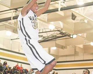 (34) Tre' Brown of Harding slams home two points Wednesday night in Warren.