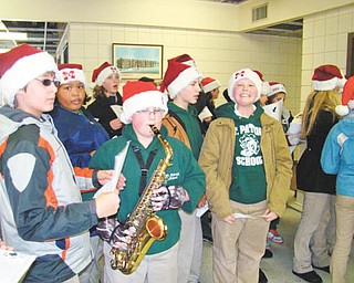 Making a joyful noise: Members of the Builders Club at St. Patrick School in Hubbard spread holiday cheer as they sang carols while walking from the school on Dec. 17 to Hubbard Manor, where they were greeted by residents of the manor. As one student played a saxophone the group sang as they walked through the halls and left a holiday gift at each apartment door. The caroling and gift-giving have been a tradition of the Builders Club for more than 10 years.