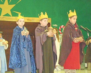 The gift of Christmas: The three kings, who took gifts of gold, frankincense and myrrh to the manger after the birth of Jesus, are portrayed by, from left, Cooper Muccio, Jeffery Hazy and Nick Matisi as the third-grade class of Joan Matune and second-grade class of Mellony Leonard recreated the story of the first Christmas for family and friends on Dec. 20 at St. Patrick School in Hubbard. This is the first year the classes undertook such an important project. The youngsters began practicing their roles in October. 