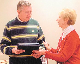 Well-deserved award: During its annual dinner on Dec. 5 Springfield Township Historical Society presented an Appreciation Award to East Fairfield Coal Co. in recognition of the company’s continued support. The presentation was conducted by, at right, Zonda Haase, society president, and the award was accepted by Tom Mackall, president of the company. Officers of the society include Rusty George, vice president; Ruth Denmeade, secretary; Karen Datillo, treasurer; and Ray Davis and Larry Ricketts, trustees. The dinner was coordinated by Mary Lyda, and it took place at the home of Don and Kari Snyder.