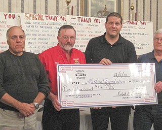 Supporting the foundation: On Dec. 12 the Valley Cruzers Car Club presented a check for $2,000 to the Touched by Nathan Foundation, formed by Kenneth and Vicki Pavalko in memory of their son. The car club has donated more than $14,000 to the foundation in the past four years. Participating in the check passing event during a meeting at A La Cart Catering in Canfield, were, from left, Frank Imburgia, club vice president; Steve Bendel Sr., president; Pavalko, who accepted the funds on behalf of the foundation; and Bob Brown, treasurer. Club members, not pictured, are Steve Goricki, Harry Barber, Gary Monroe and their wives. Club meetings are on Saturdays during warm weather at Chili’s restaurant outside the Southern Park Mall. For more information on the club or to make a donation to the foundation, call 330-757-8324.