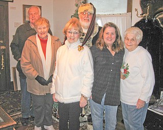 Luck of the draw: Hubbard Historical Society recently conducted a raffle for two watercolor winter farms scenes painted by local artists. One of the pictures was painted by Linda Cooper Brightwell in the late ’70s while she was a high school student. The other was created by her art teacher. Following the drawing it was determined that Rodd Coonce was the holder of the winning ticket that was drawn by Santa Claus (aka Howard Huffman). Among those joining Santa for the raffle drawing are, from left, Bob Gibson, Joan Gibson, Lucille Wilson, Jackie Orlando and Cecilia Cooper.