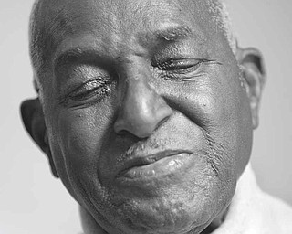 I SEE THE DREAM. On Jan. 15, 2009, at his home in Campbell, Ohio, Rev. Lonnie Simon reflects on the impact of Barack ObamaÕs election on the civil rights movement after being a chanter leader during one of the 1965 marches on Montgomery with Martin Luther King Jr. Simon received an illustration as a Christmas gift from his daughters featuring King saying, ÒI had a dream,Ó himself saying, ÒI saw the dream,Ó and Barack Obama saying, ÒI am the dream.Ó
