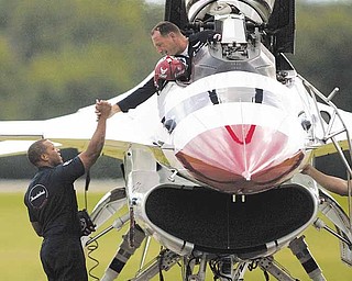TEAMWORK. Crew Chief, Staff Sgt. Anthony Stewart, of New Orleans, LA, shakes hands with Thunderbird Slot Pilot, Maj. Sean Gustafson, of Kenora, Ontario, at the Youngstown Air Reserve Station in Vienna, OH on August 6, 2009. The Thunderbirds arrived at the base in preparation for a performance for the 2009 Youngstown Air Show, the first air show at the base in nearly a quarter century.