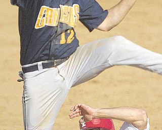 YSU's Tom Clayton (22) arrives safely at third base squeezing beneath the legs of Canisius' Drew Pettit (12) during the bottom of the 6th inning on Wednesday afternoon at Cene Park in Struthers.