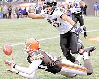 Cleveland Browns wide receiver Brian Robiskie, bottom, catches a 29-yard touchdown pass against Baltimore Ravens cornerback Chris Carr (25) in the first quarter of an NFL football game Sunday, Dec. 26, 2010, in Cleveland. The scoring pass was thrown by wide receiver Mohamed Massaquoi.