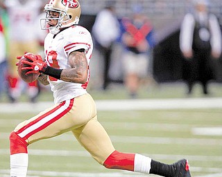 San Francisco 49ers' Ted Ginn runs a punt back 78-yards for a touchdown during the second quarter of an NFL football game against the St. Louis Rams, Sunday, Dec. 26, 2010, in St. Louis.