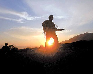 U.S soldiers of  2nd Platoon Bravo Company 2-327 patrols as sunset  in Chowkay district of Kunar province in eastern Afghanistan near Pakistan border on Sunday, Dec 26, 2010.