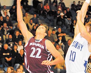 Boardman's #22 Dave DeBernardi puts a shot up while Poland's #10 Colin Reardon goes for the swat.