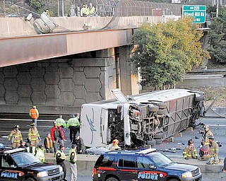 In this March 2, 2007 file photo, a charter bus carrying the Bluffton University baseball team from Ohio is seen after it plunged off a highway ramp in Atlanta, and slammed into the I-75 pavement below. The Ohio Supreme Court says a university's insurance coverage extended to the charter bus that crashed, killing five student baseball players and two others. An attorney for a Blufffton University player severely injured in the wreck says the 5-2 ruling issued Tuesday, Dec. 28, 2010, provides up to $16 million more in insurance money to pay claims.