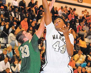 Warren Harding's #44Craig McFerrin puts up a shot over St. V defender #33 Oliver Hidebrandt.