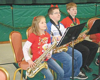 Banding together: The school band at St. Patrick School in Hubbard performed a concert for other students, family members and friends on Dec. 21 at the parish center. Laura Volenik, band director, conducted the students as they presented a program of holiday classics. A segment of the concert featured a saxophone performance by several students, including, from left, Mary Lyons, Tim Wirtz and Josh Chrobak. The band is open to students in grades four through eight and presents several program throughout the year.