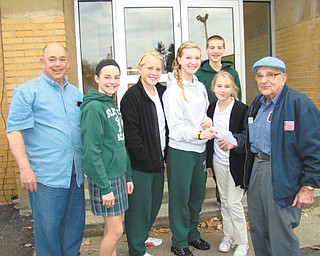 Help for those in need: Student council members at St. Patrick School in Hubbard continued their tradition of leadership in the school by conducting a food drive for St. Vincent De Paul Society, which operated a food pantry at St. Patrick Church in Hubbard. In addition to collecting boxes of food, the students also collected monetary donations. The funds will be used by the society to purchase items for those in need. Pictured as a check from the student council and checks from staff members of the school are presented are, from left, Mike Heincer of St. Vincent De Paul; Concetta Siedler, Katie Conlan, Emily Manion, Justin Oaks and Sandy Slenker, students; and Dan Williams of St. Vincent De Paul.