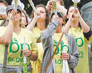 In this July 13, 2010 file photo, demonstrators from the group 'Vuvuzelas for BP', blow vuvuzelas during a protest across the street from the BP headquarters in central London. As the Gulf oil spill gushed out of control this summer, BP's financial liabilities expanded so rapidly that experts wondered if the company had drilled its last well. Only months later, though, the British oil giant has pulled itself back from the brink. 