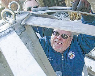 Mickey Koziorynsky, a Youngstown Street Department superviser, secures the two halves of the city’s New Year’s Eve ball. Koziorynsky is part of a crew of five that have lowered the city’s New Year’s Eve ball since 2000. A fireworks show will be provided at 9 p.m. and just after midnight at the Covelli Center.