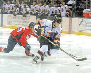 Phantom Mike Ambrosia moves in to score Wednesday night. He was defended by Andrew Miller of the Des Moines Buccaneers.