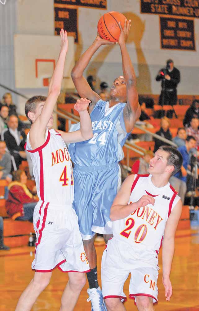Youngstown East's #24 Antonio Woods puts up a shot while Cardinal Mooney's #42 Doug Caputo and #20 Joe DeNiro get in front of him.
